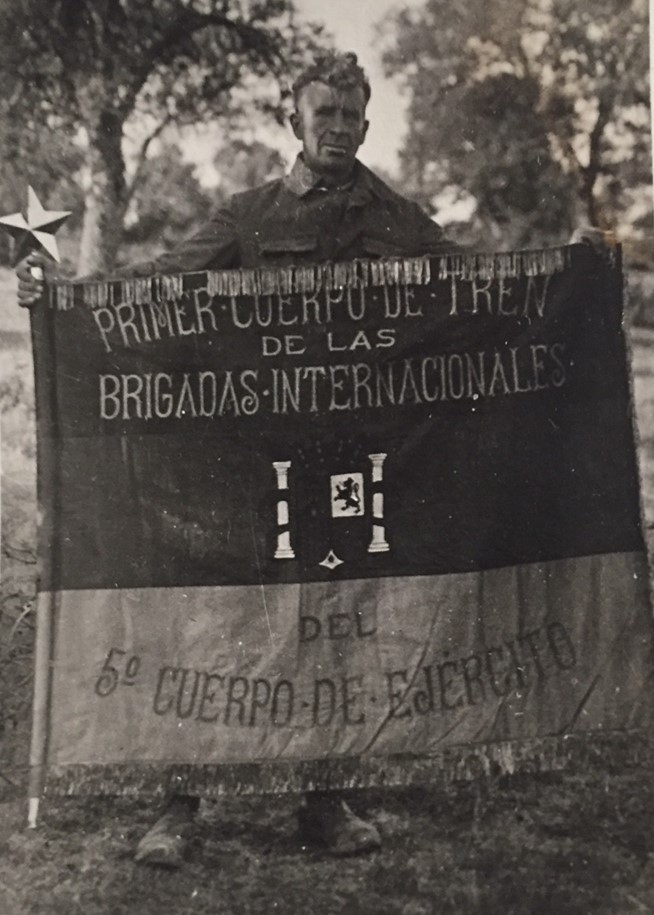 Mark Thornton with the Flag of the Fifth Army Corps Primer Cuerpo de Tren, 1938, Courtesy Georgia Wever.